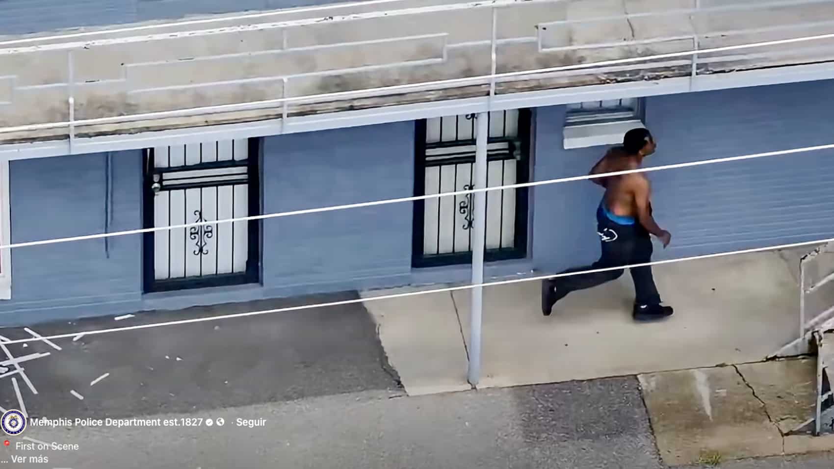 Drone view of Isaiah Butler standing near a broken window in Memphis.