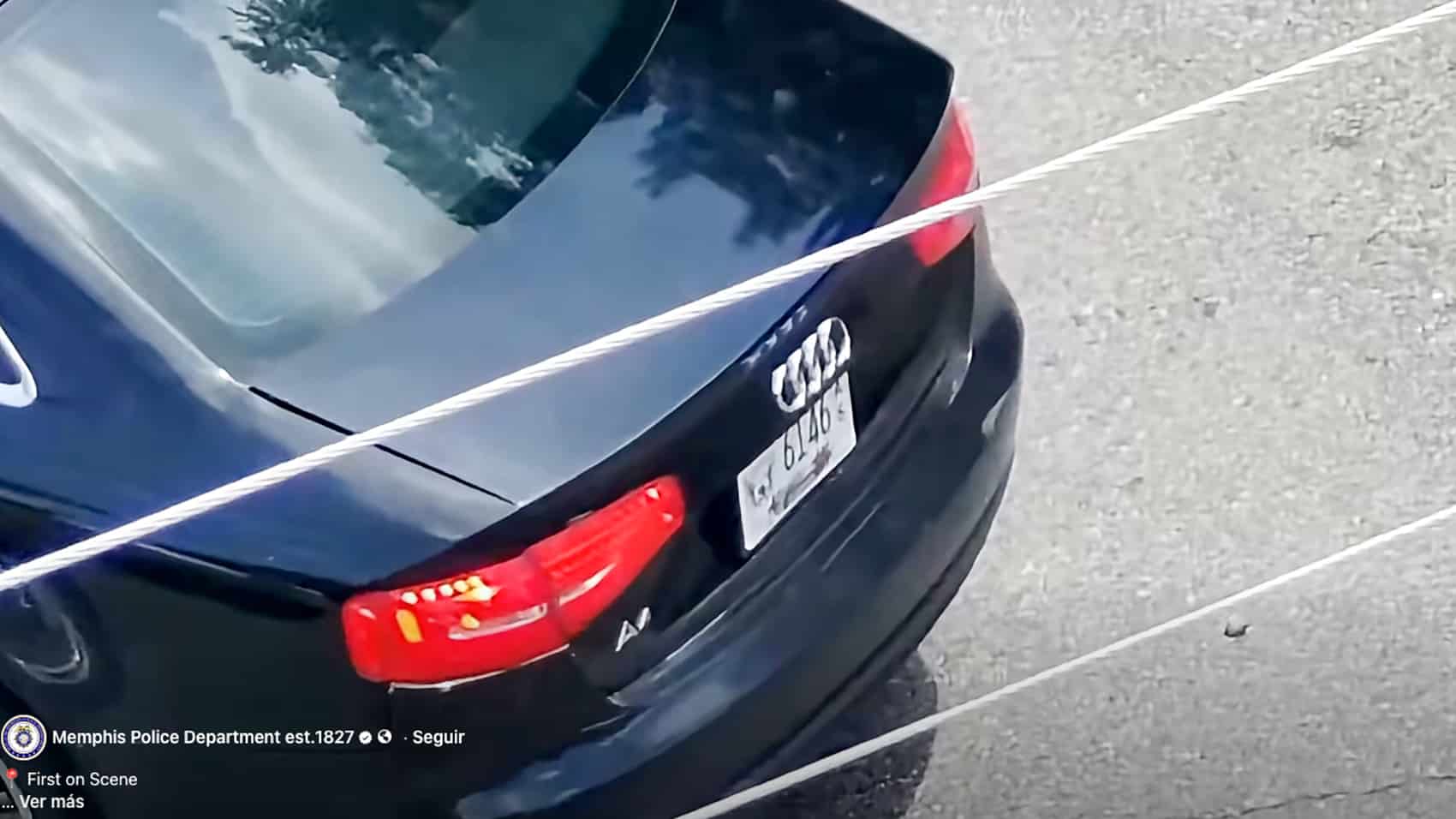 Drone footage following the suspect as he walks toward a parked black Audi.