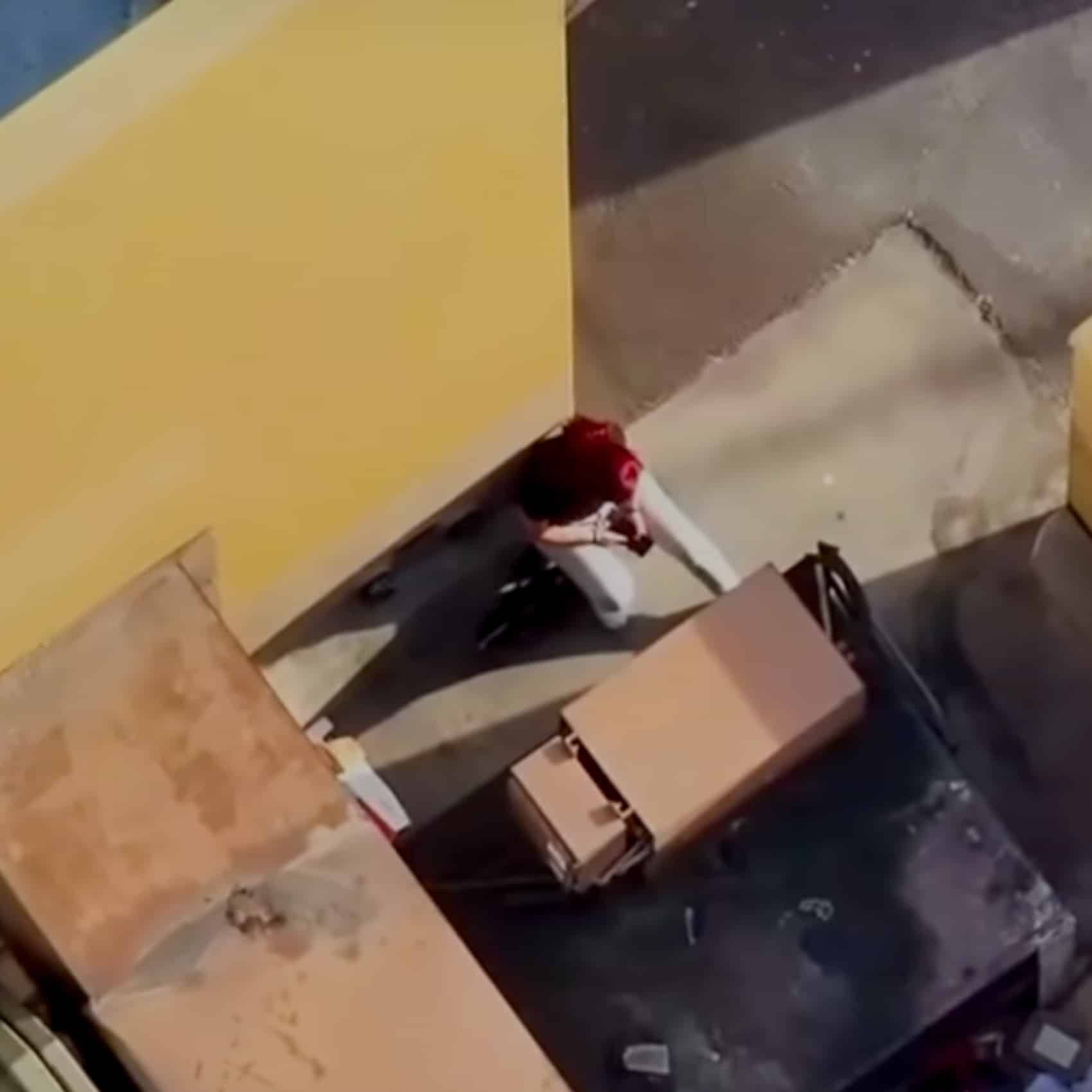 Drone footage of two theft suspects tucked into the dumpster area behind a Michaels store.