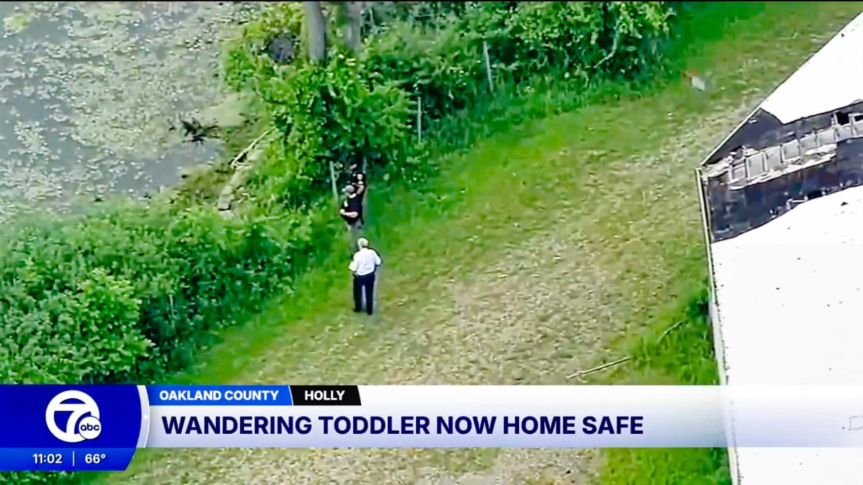 Aerial search footage over wooded ground near Holly, Michigan.