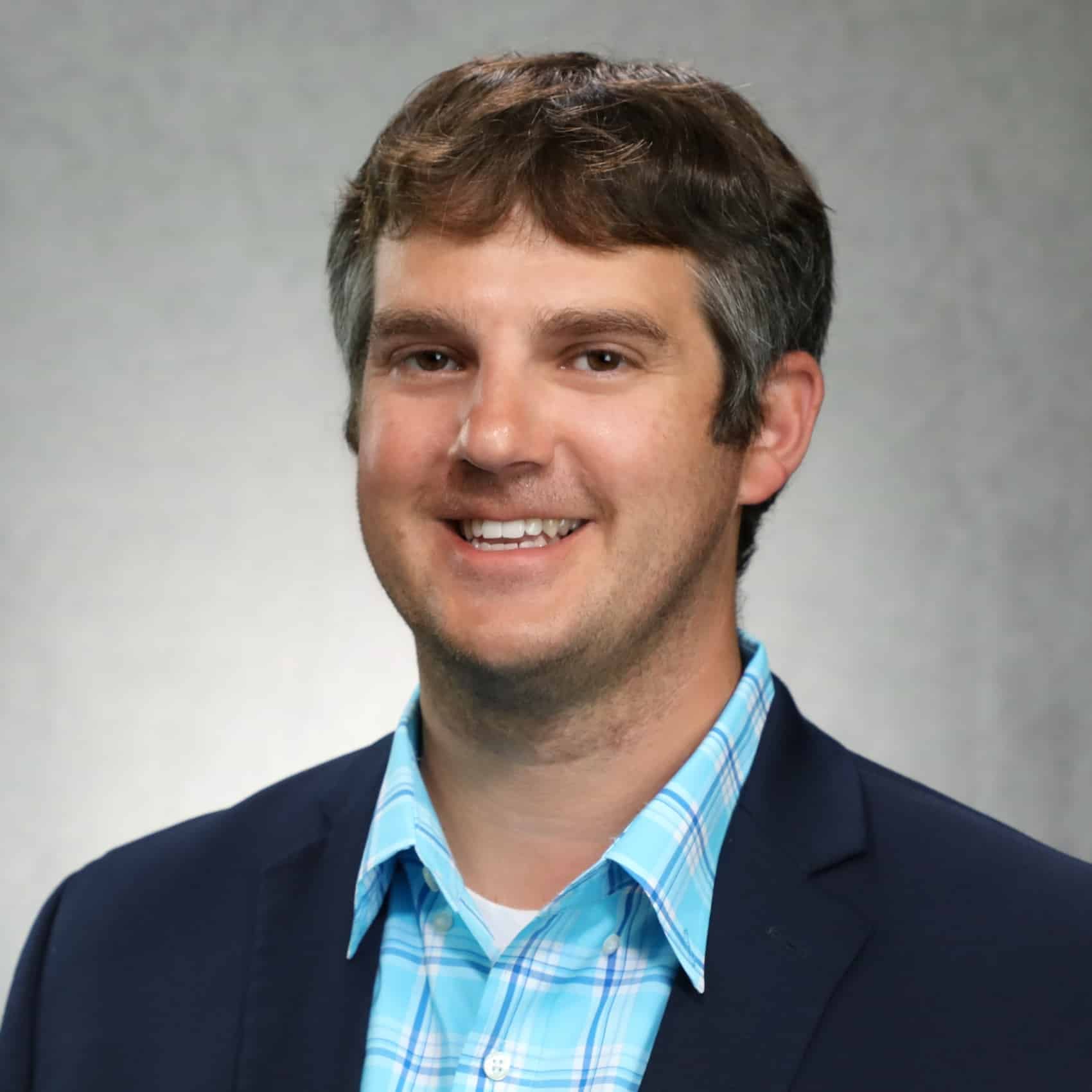 Portrait of University of Cincinnati economist Michael Jones in a dark suit.
