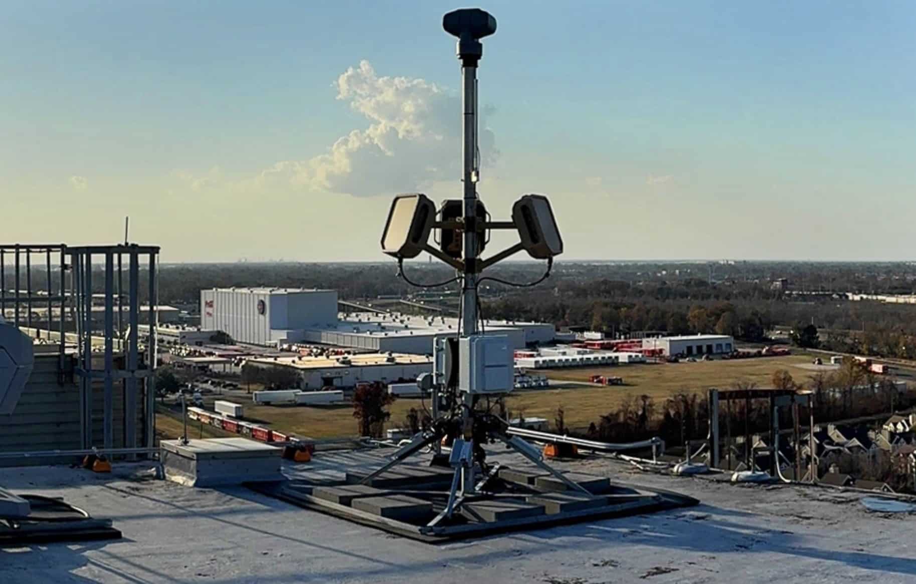 Echodyne radar array mounted on a rooftop mast overlooking an industrial park.