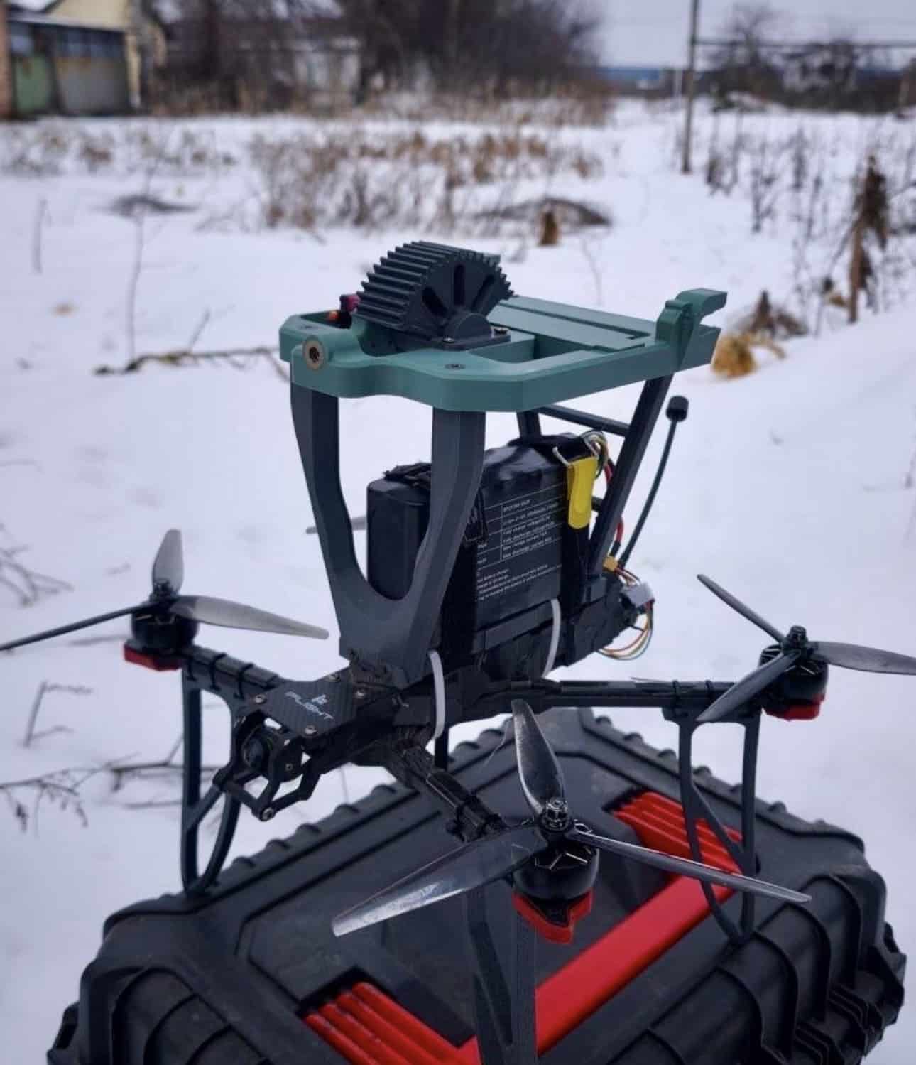 Close view of the wing mount and battery pack strapped above the airframe.