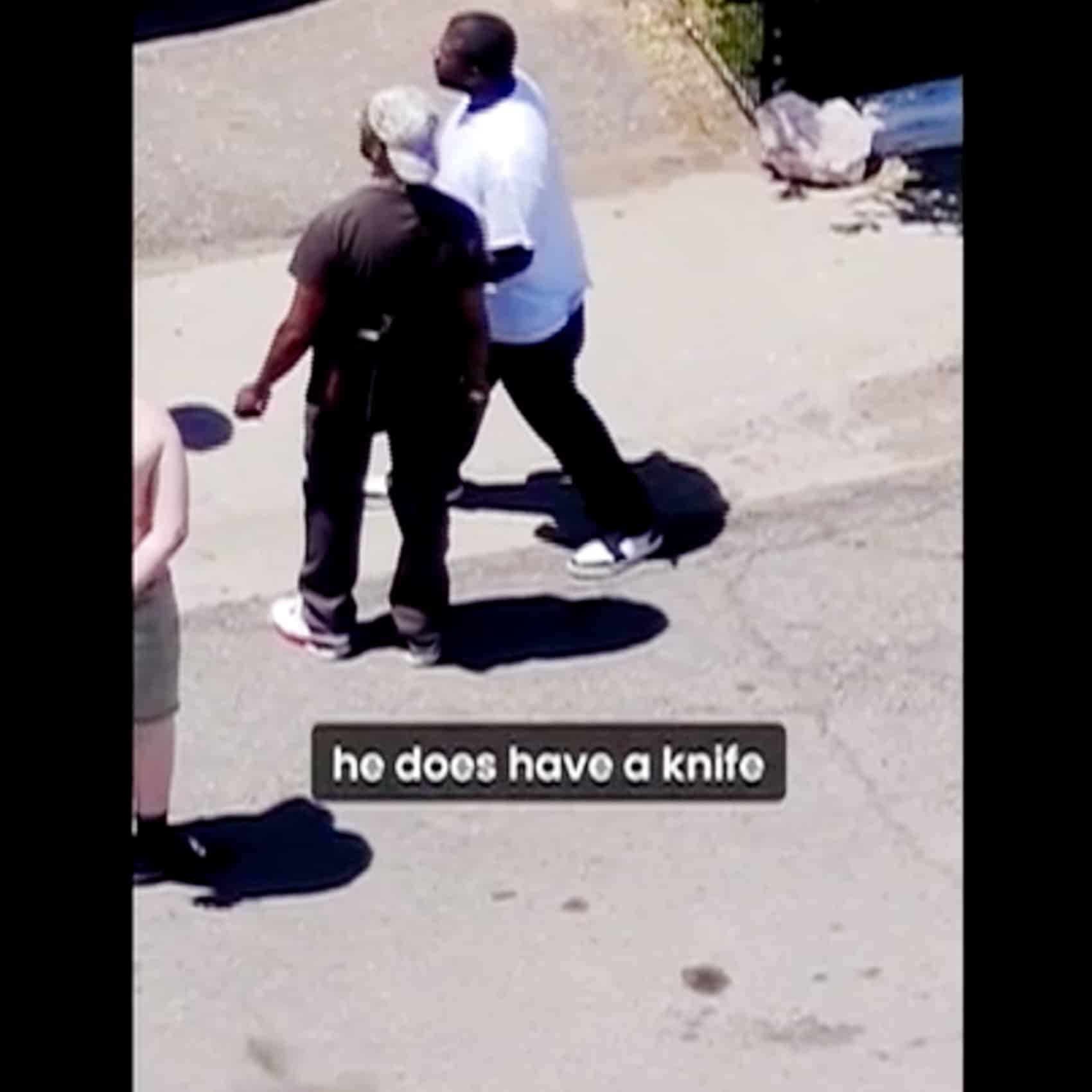 The operator drops the drone lower to show officers a man holding a knife.