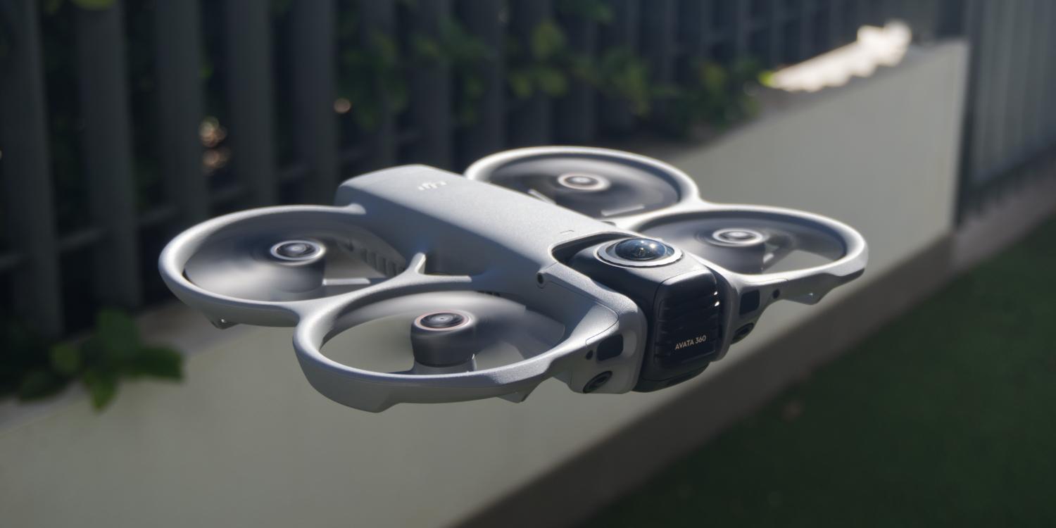 DJI Avata 360 drone hovering outdoors near a fence