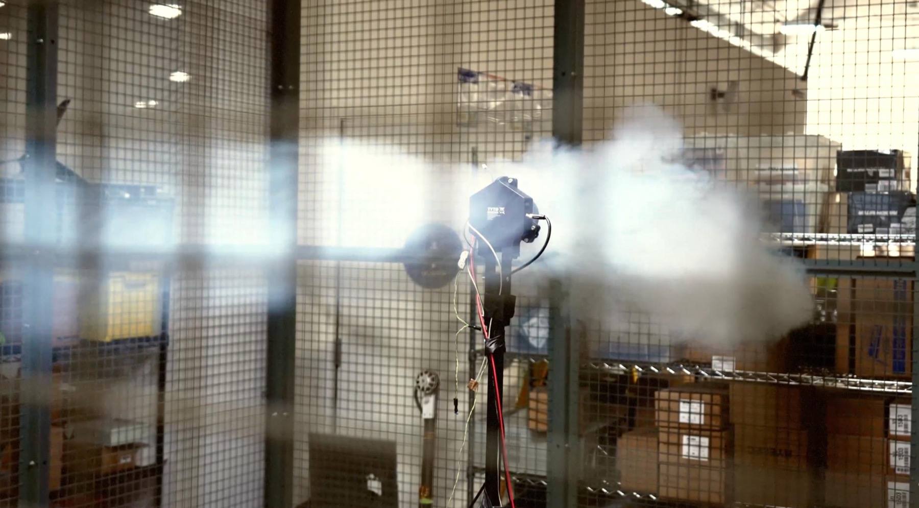 Smoke visualizing airflow around a spinning DoorDash Air propulsion test rig