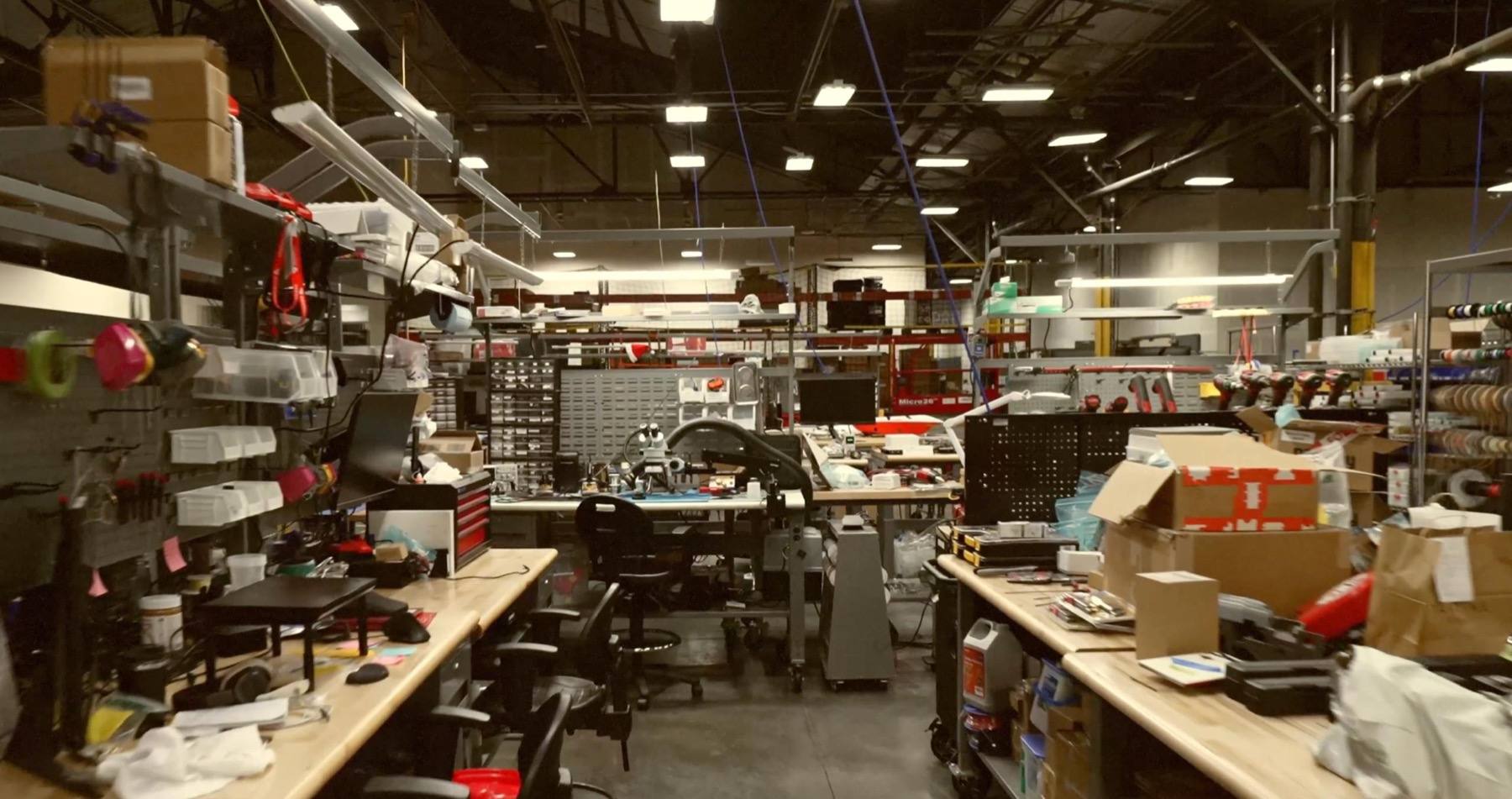 Interior of the DoorDash Labs engineering workshop with workbenches, tools, electronics and prototyping equipment