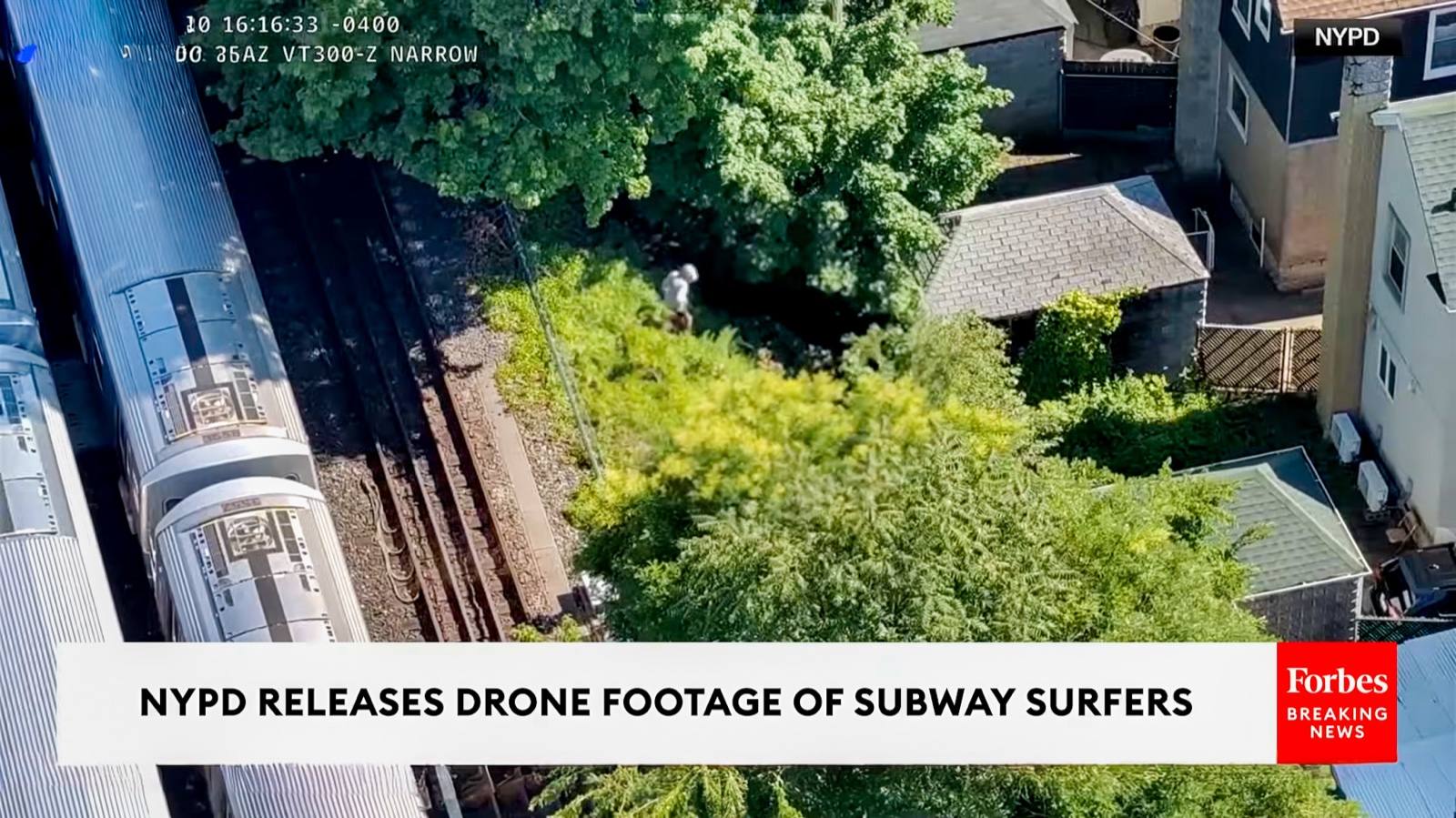 Aerial NYPD footage of people riding on top of a Brooklyn subway train