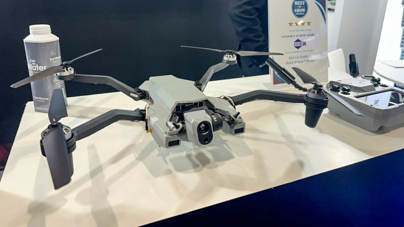 Red Cat Black Widow drone displayed on a stand at a trade show