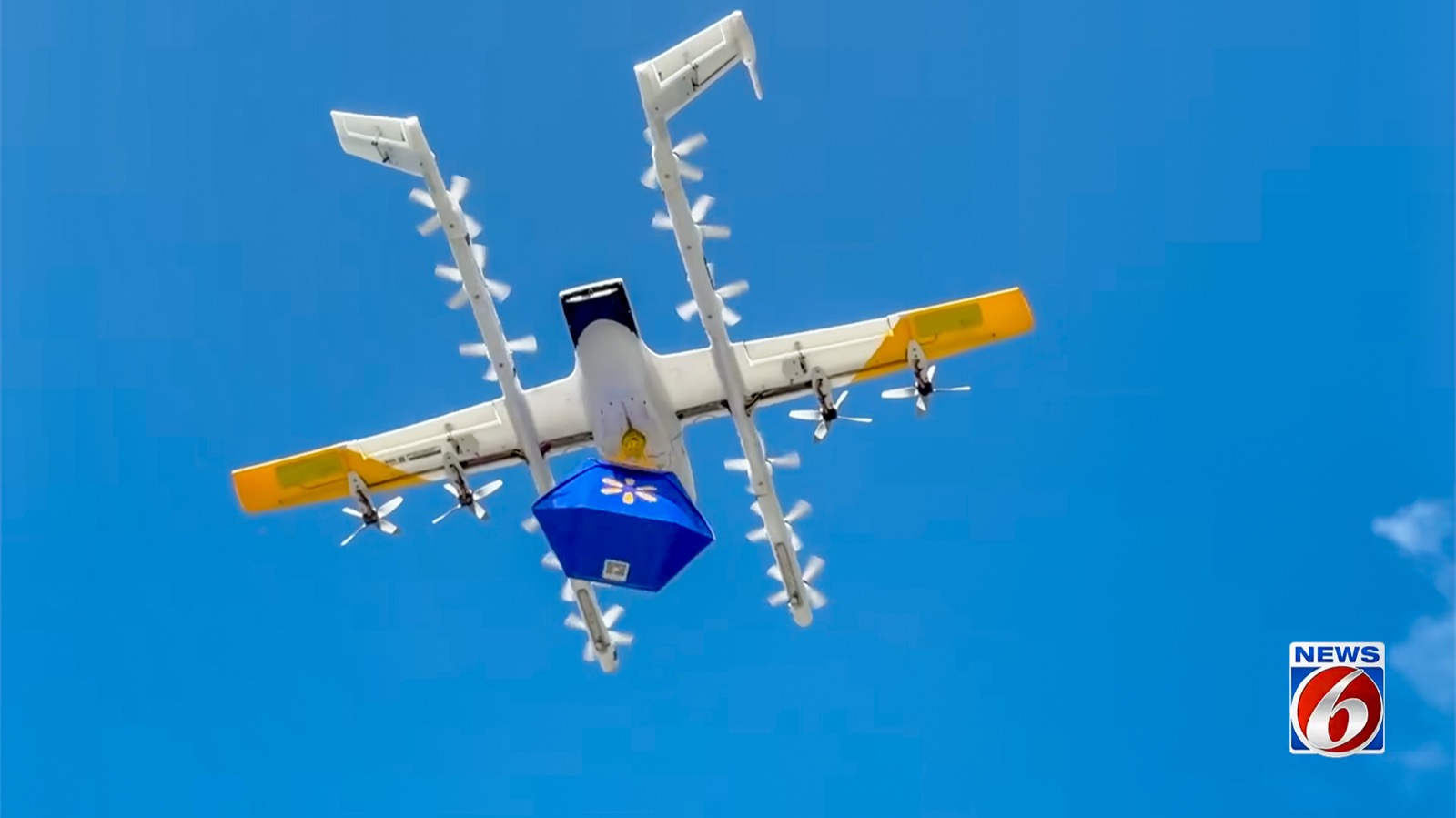 Wing drone lowering a Walmart delivery package