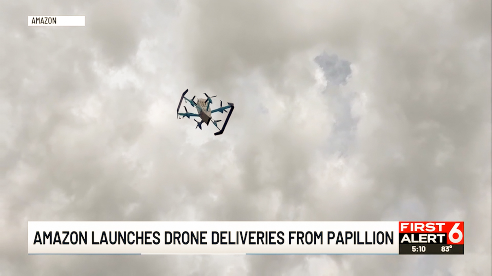Amazon Prime Air MK30 drone flying against a cloudy sky over Papillion, Nebraska during launch-day coverage