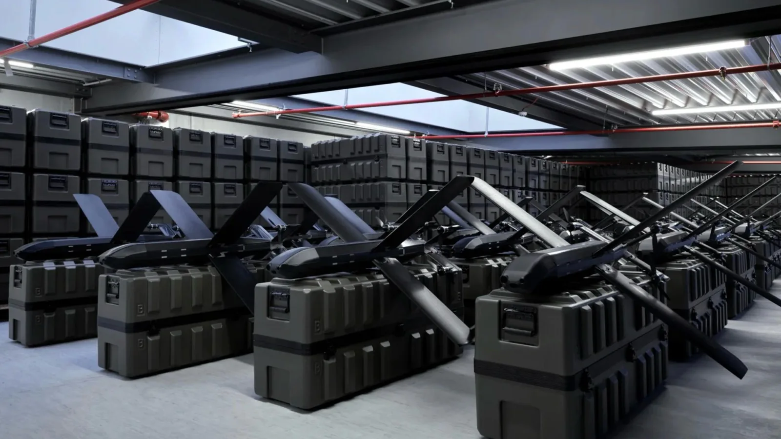 Rows of Helsing HX-2 strike drones with X-shaped wings resting on olive-green shipping cases in a production warehouse