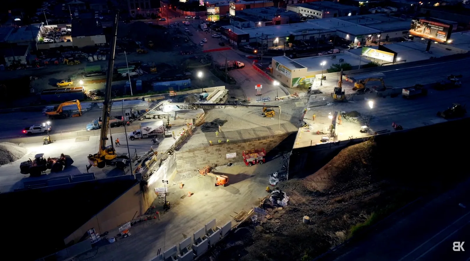 Aerial night view of the I-95 reconstruction site at Cottman Avenue in Philadelphia, with cranes, excavators and floodlit crews working on the new bridge structure