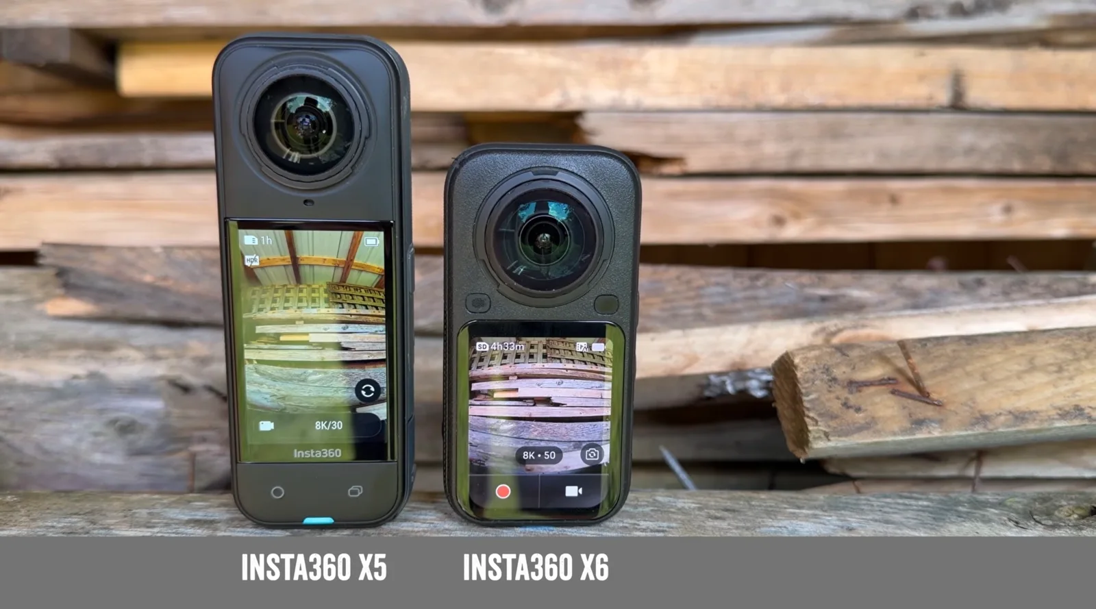 Insta360 X5 and Insta360 X6 360-degree cameras standing side by side on a wooden plank, screens on showing live previews and 8K recording modes