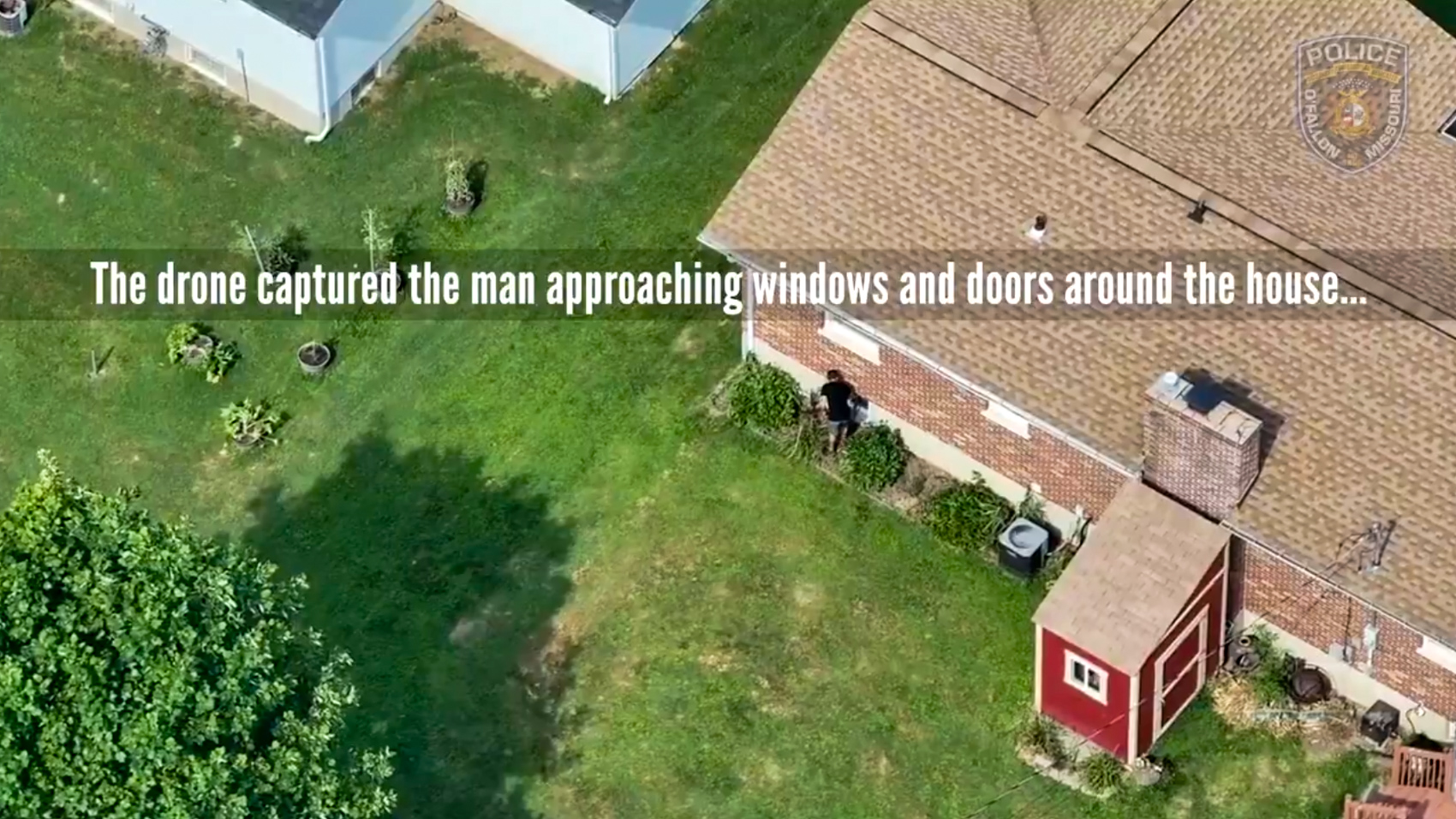 Aerial drone view of a brick house and backyard as a man approaches windows and doors, with an on-screen caption from police video.