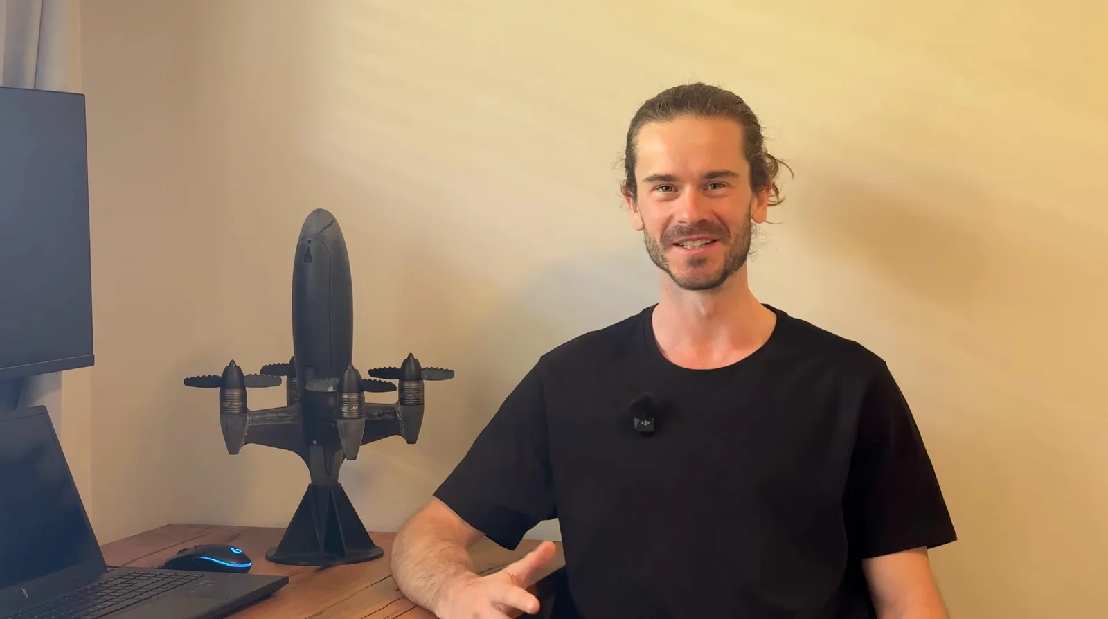 Benjamin Biggs sitting beside his Blackbird speed drone, the quadcopter that set the 626 km/h Guinness World Record in December 2025