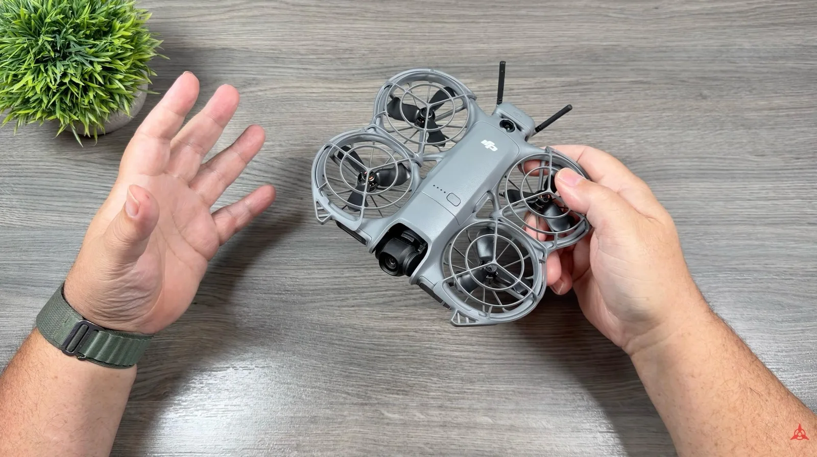 DJI Neo 2 held in hand showing its built-in propeller guards