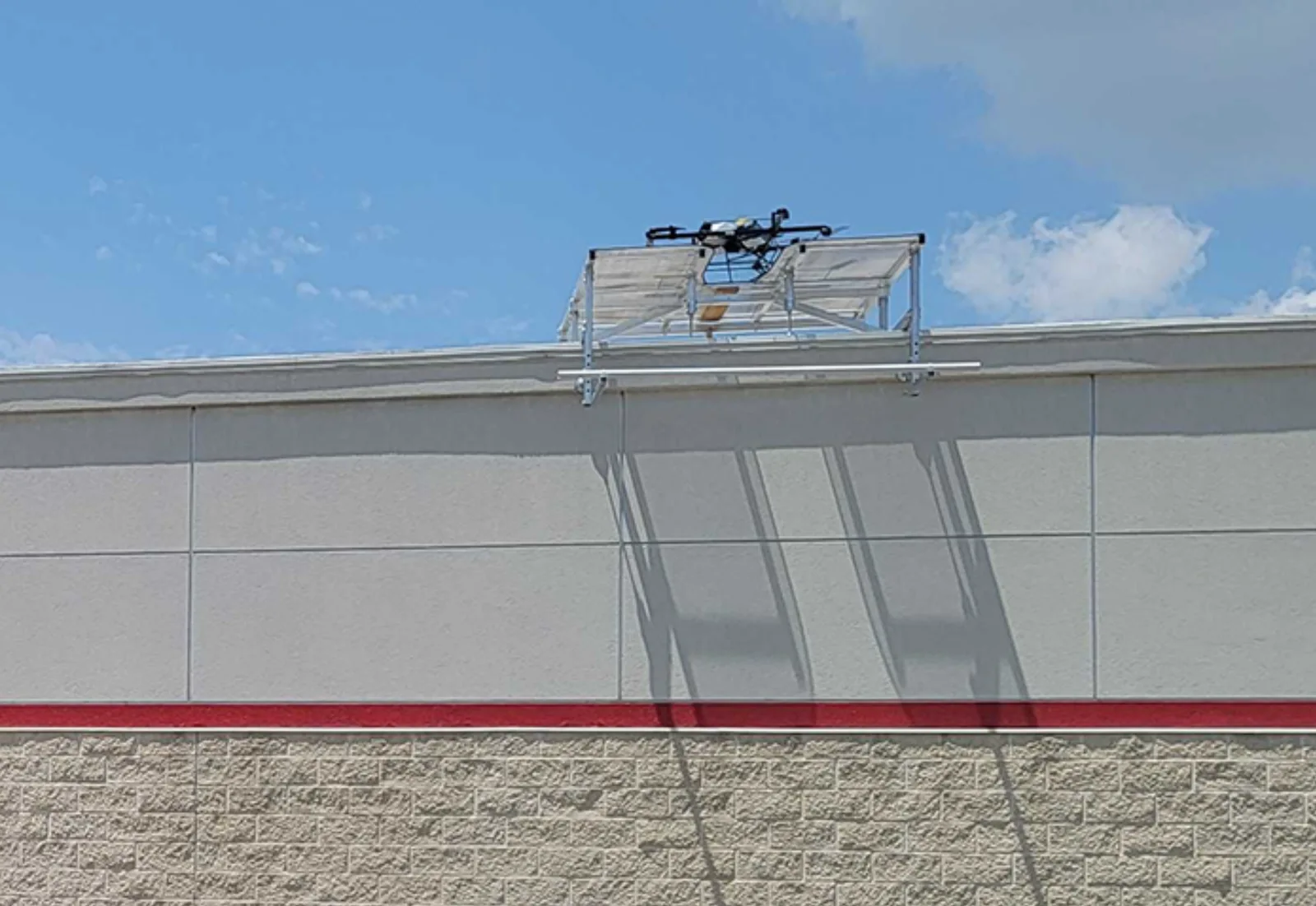 Flytrex delivery drone perched on a rooftop docking station atop a restaurant building