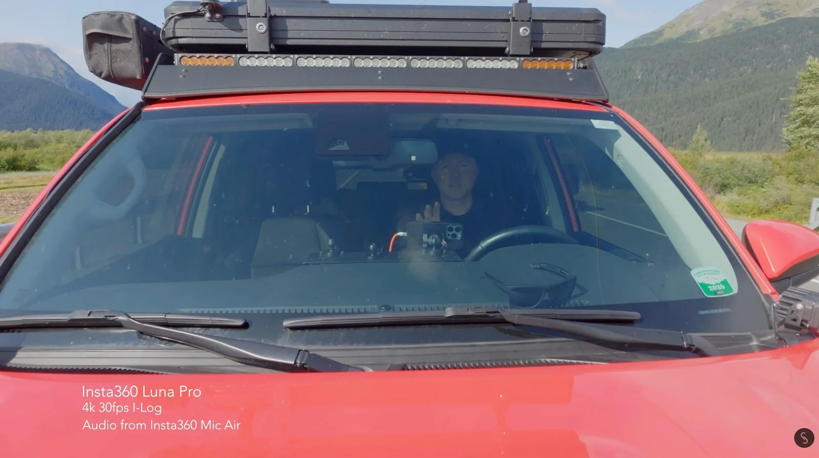 Insta360 Luna Pro camera mounted on a truck dashboard filming the driver through the windshield in Alaska