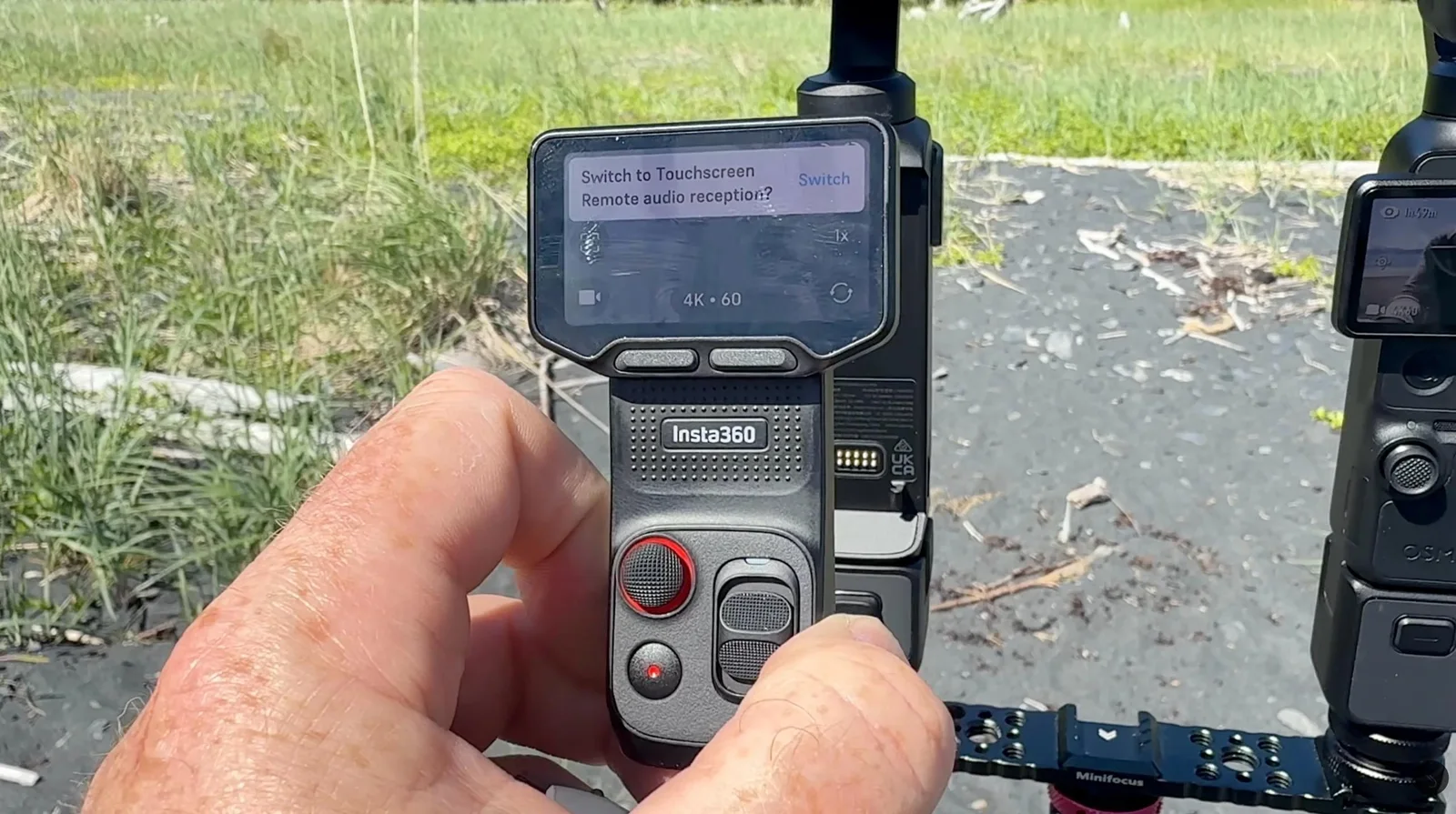 Insta360 Luna Pro remote controller showing a touchscreen switch prompt