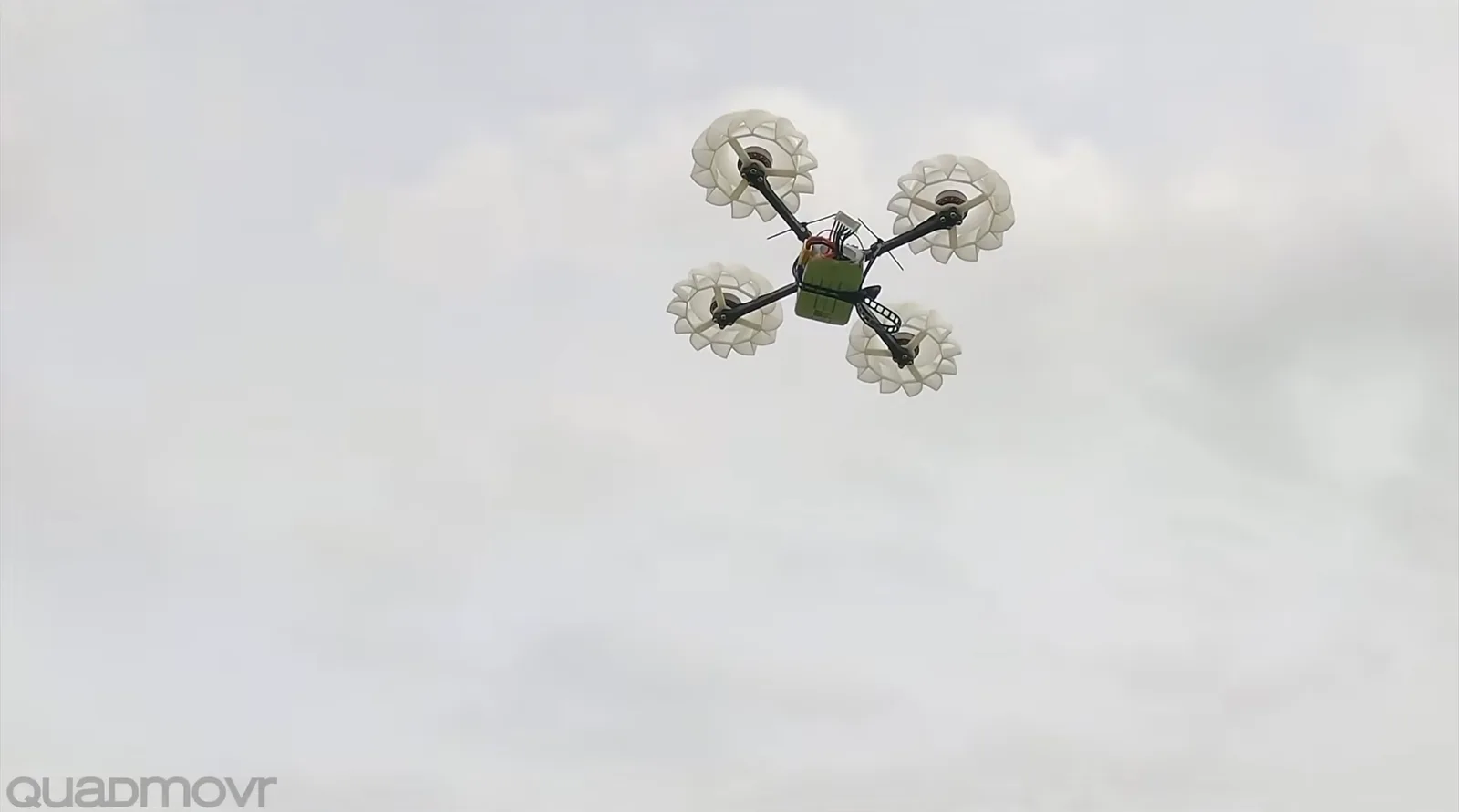 Quadmovr's experimental quadcopter with 3D printed radial impellers flying against a cloudy sky