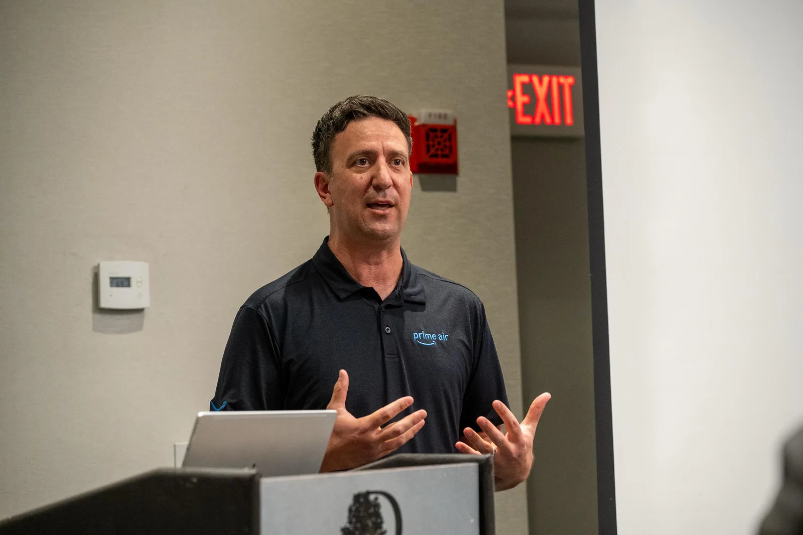 Tareq Wafaie of Amazon Prime Air speaking at a podium during a drone delivery presentation