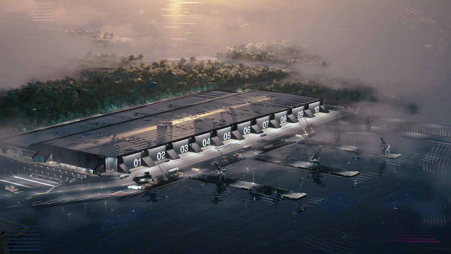 Rendering of a long dark factory building with ten numbered bays facing a pier, cranes and open water at dusk