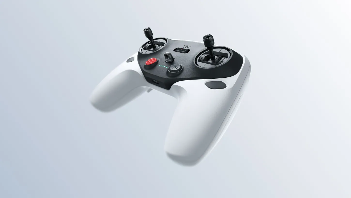 White and black Antigravity Remote Controller with two control sticks, a red button and a power button, photographed against a pale grey background