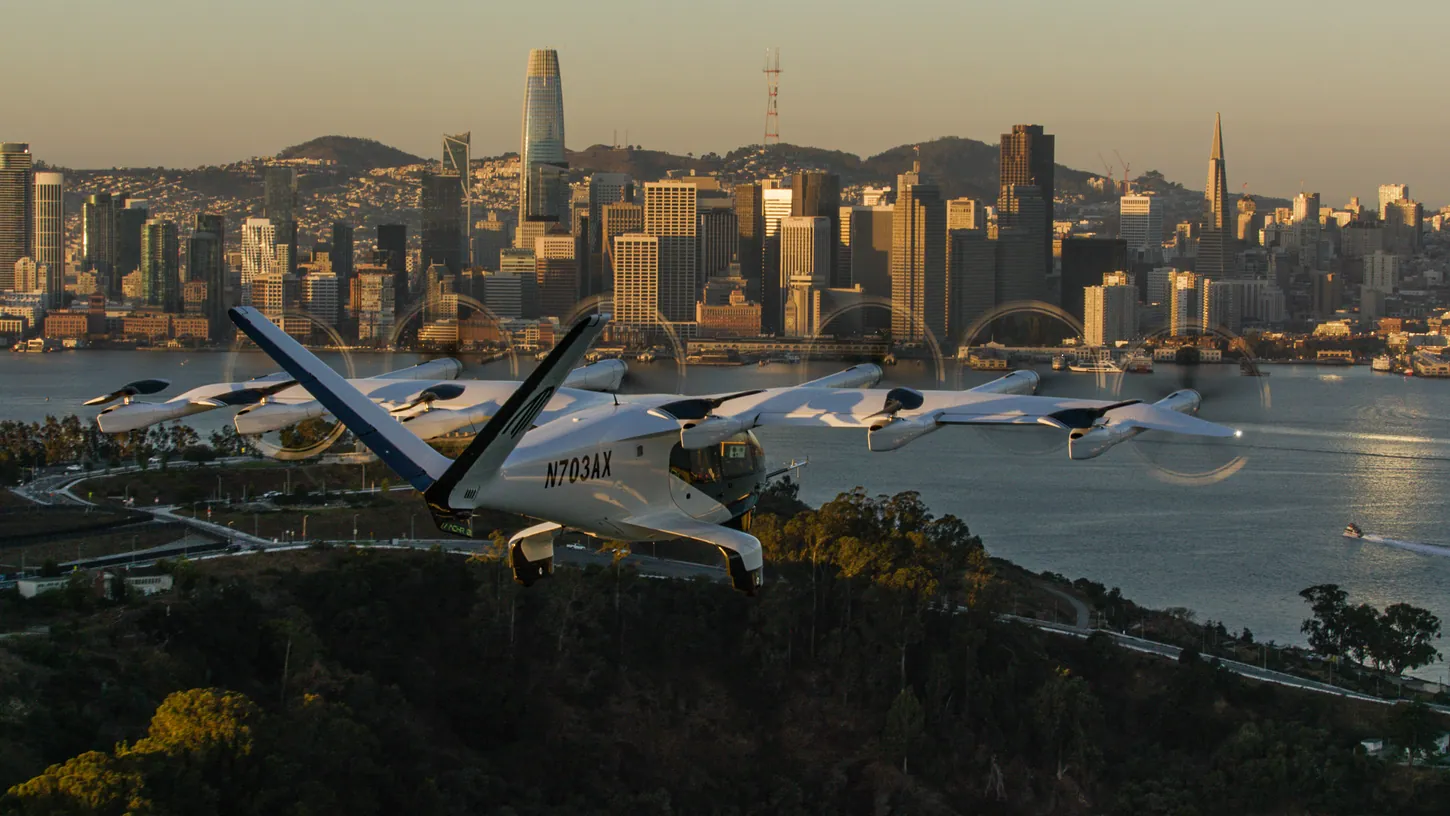 Archer Midnight eVTOL N703AX flying past the San Francisco skyline at golden hour
