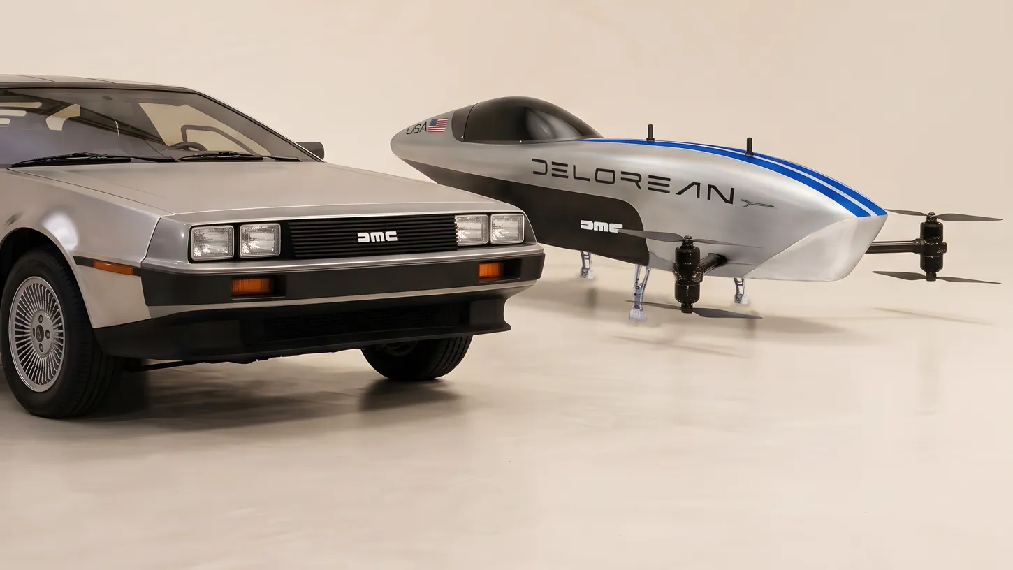 Stainless steel DeLorean DMC-12 parked beside the silver Airspeeder Mk3C racing eVTOL in DeLorean livery in a photo studio