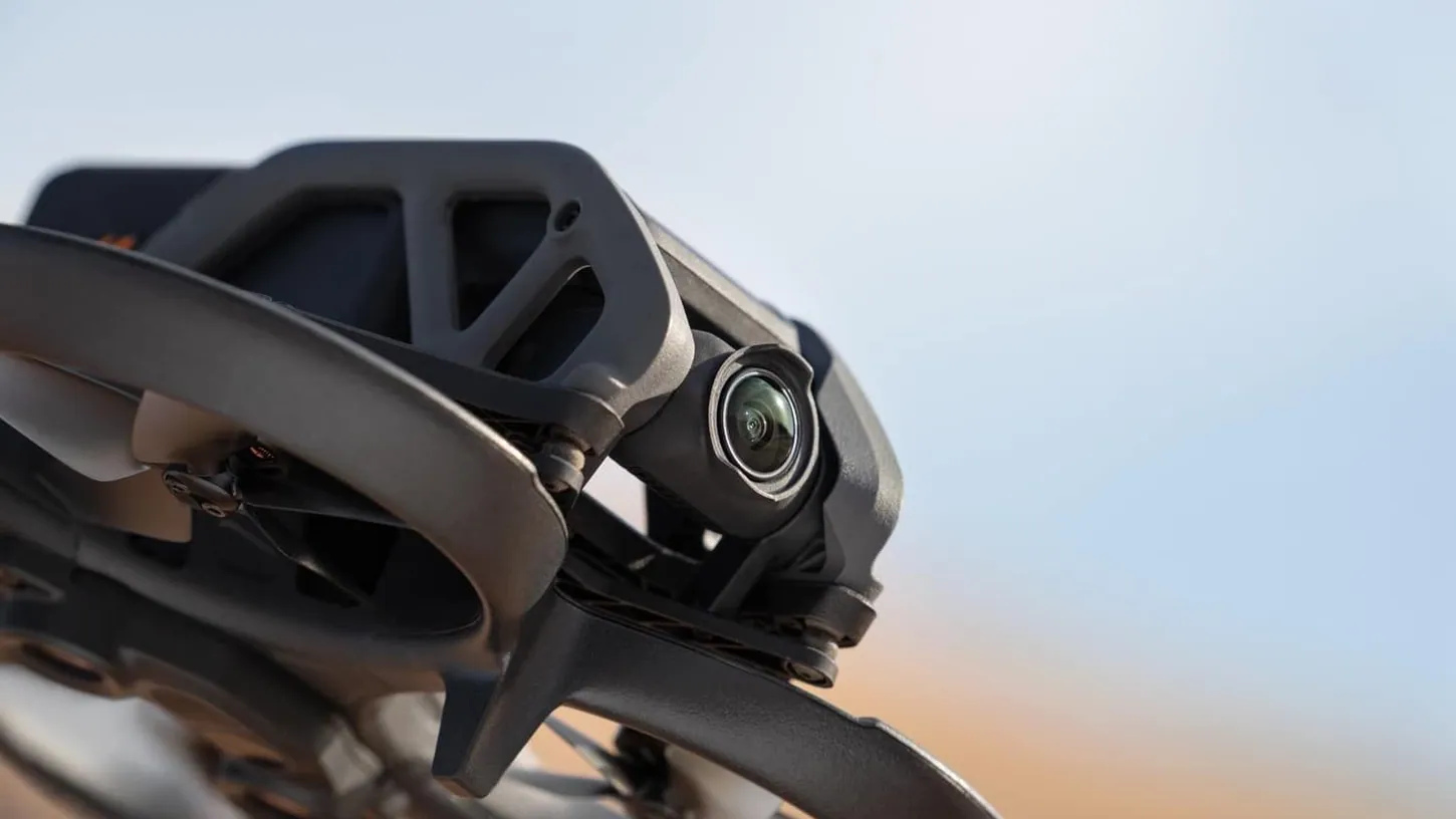 Close-up of the original DJI Avata's camera and propeller guards against a blurred desert sky