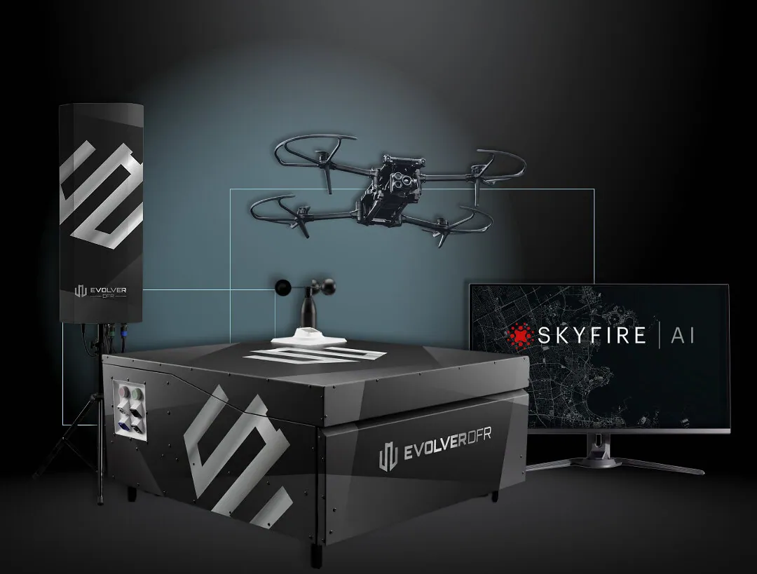 Evolver DFR system render: a black DBOX docking station with a weather sensor on top, a Parrot ANAFI UKR drone above it, an antenna mast on a tripod and a monitor showing SkyfireAI software