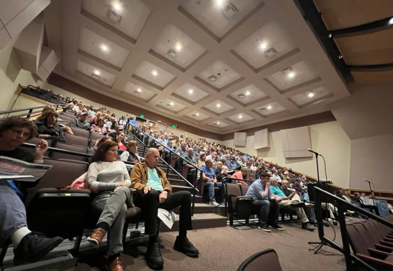 Packed Mill Pond School auditorium with residents filling the raked seating during the Westborough Select Board meeting on Amazon drone delivery