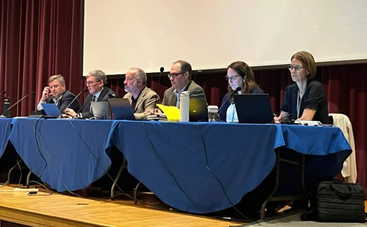 Six members of the Westborough Select Board and town staff seated at a blue-draped table on the Mill Pond School stage during the October 1, 2026, meeting on Amazon Prime Air
